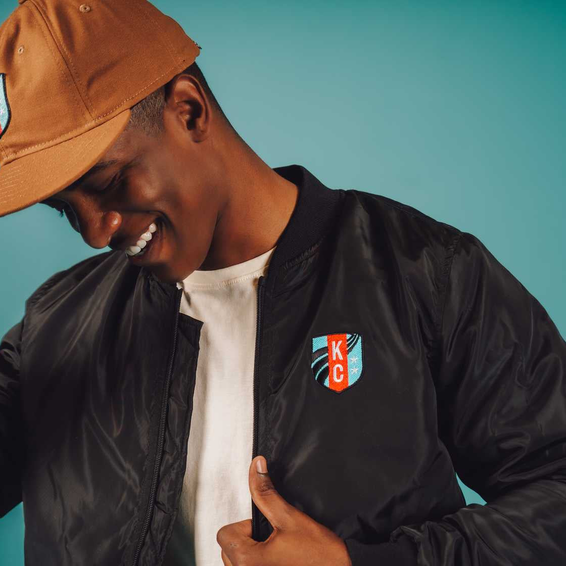 Unisex Black Crest Bomber Jacket Front on Model