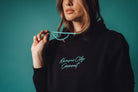 Unisex Black Teal Script Hoodie Zoomed In on Model