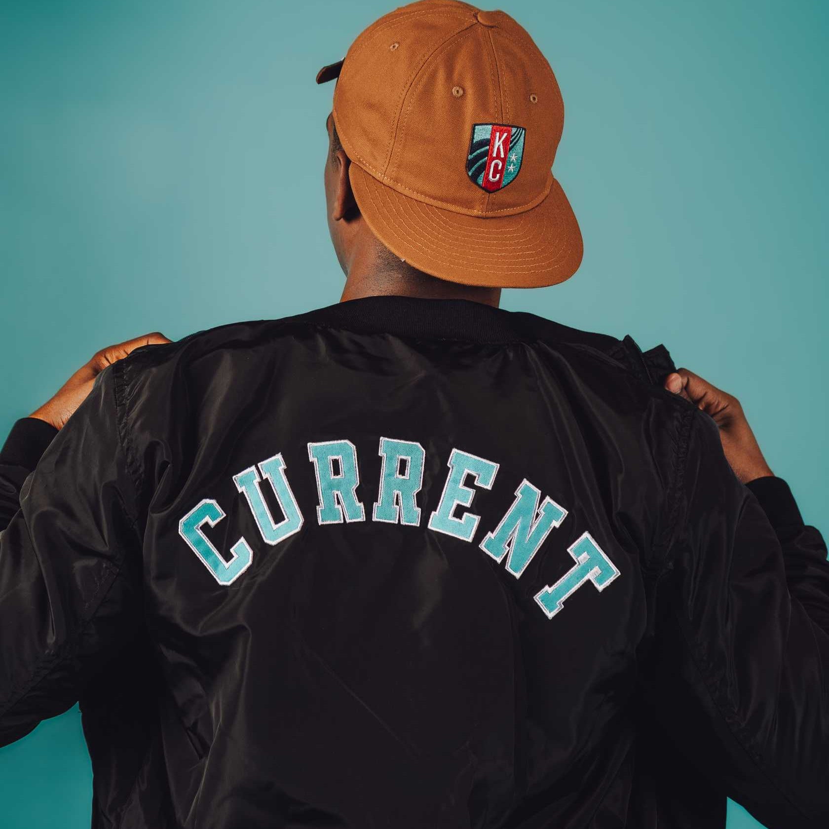 Unisex Black Crest Bomber Jacket Back on Model