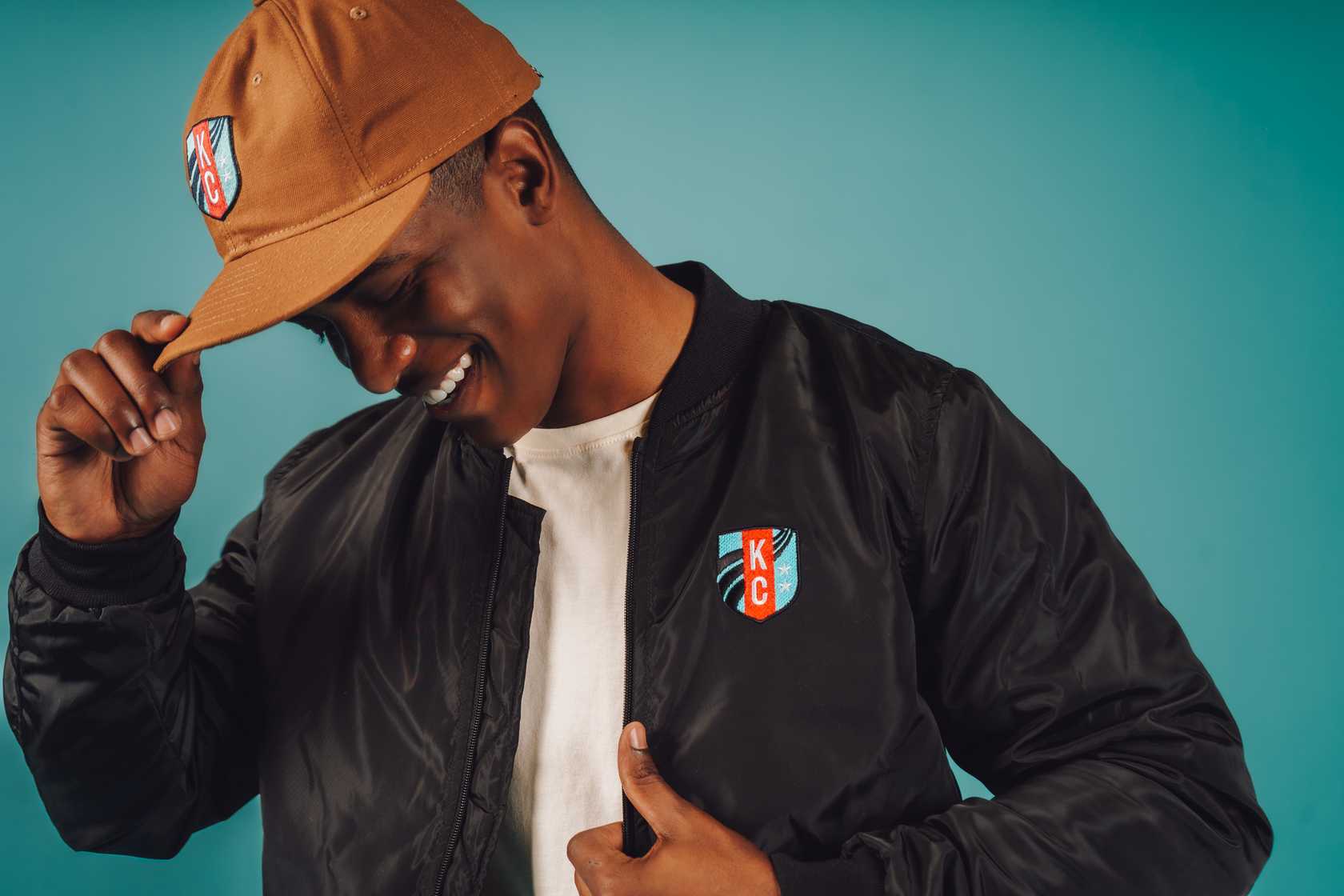 Unisex Black Crest Bomber Jacket Front on Model