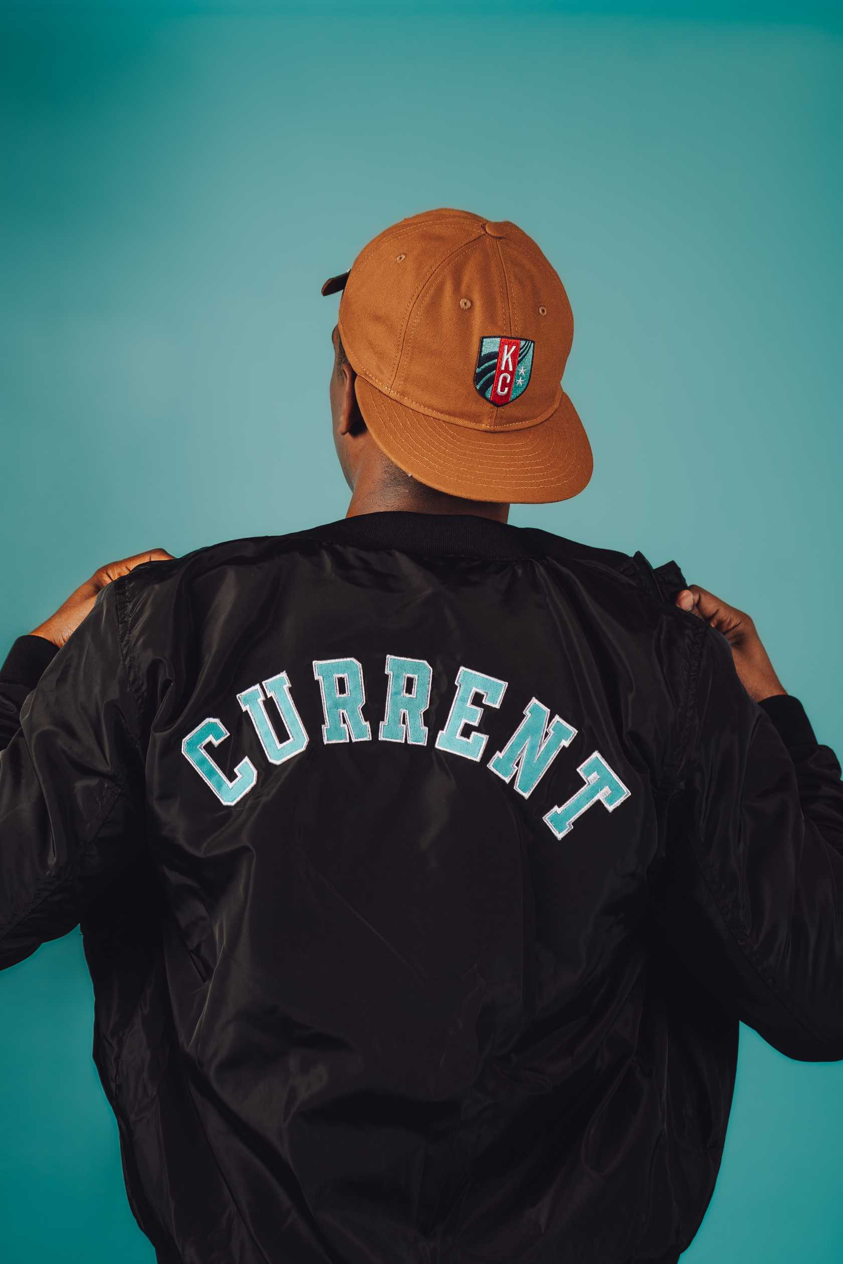 Unisex Black Crest Bomber Jacket Back on Model